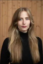 Portrait of Kat Hicks in a black turtleneck.